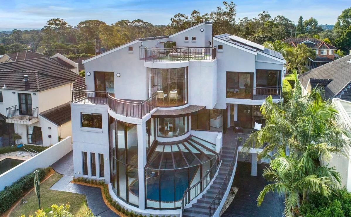 An aerial view of the rear elevation, showing the stair tower, balconies, terrace and pool room.