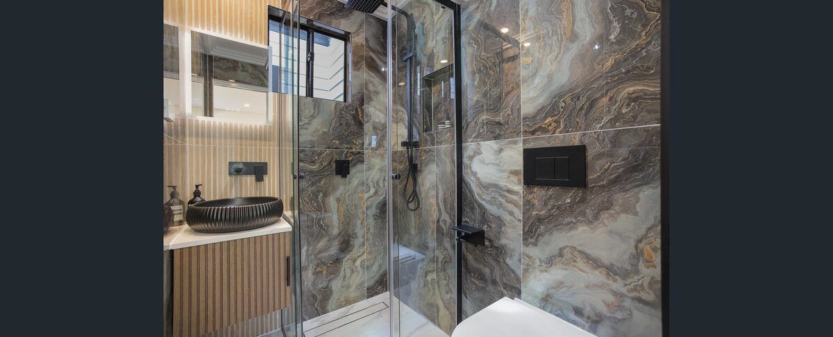 The finished bathroom with a dramatic stone feature wall