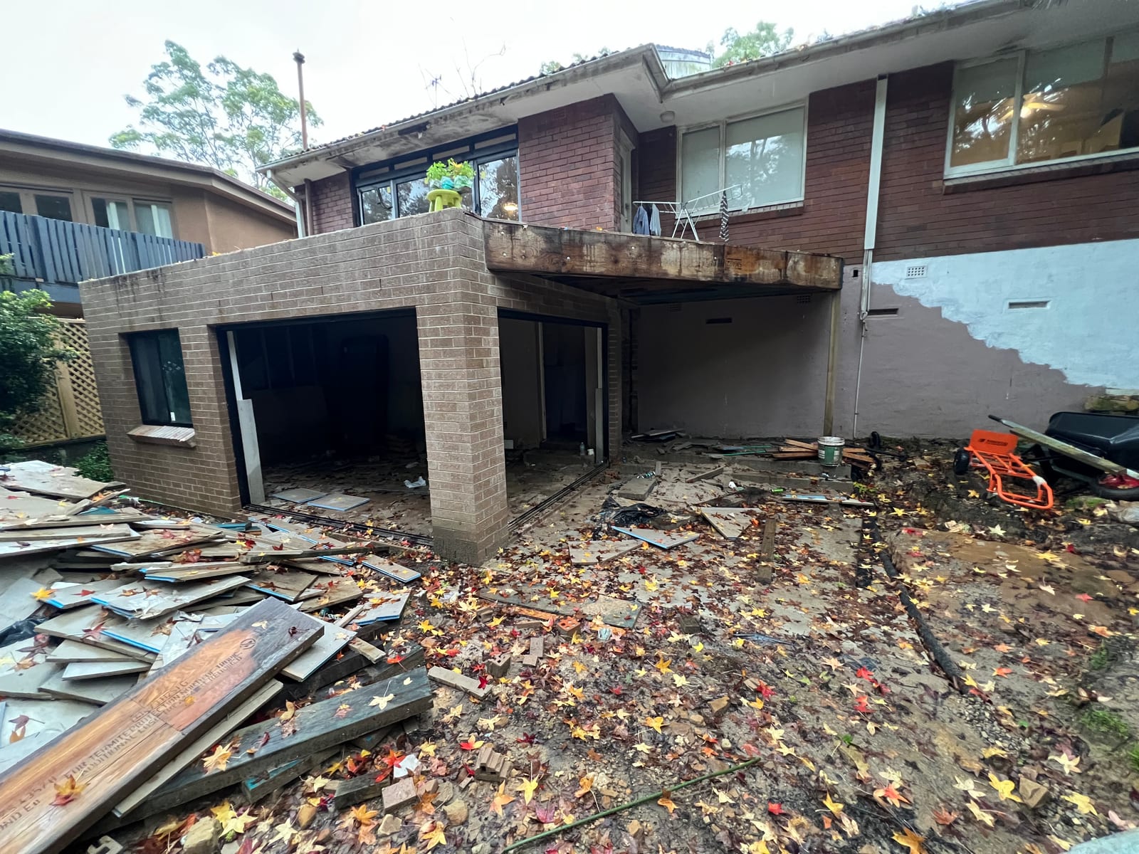 The new lower-ground level's brick shell mid-build, with a window installed and the sliding-door opening still unglazed
