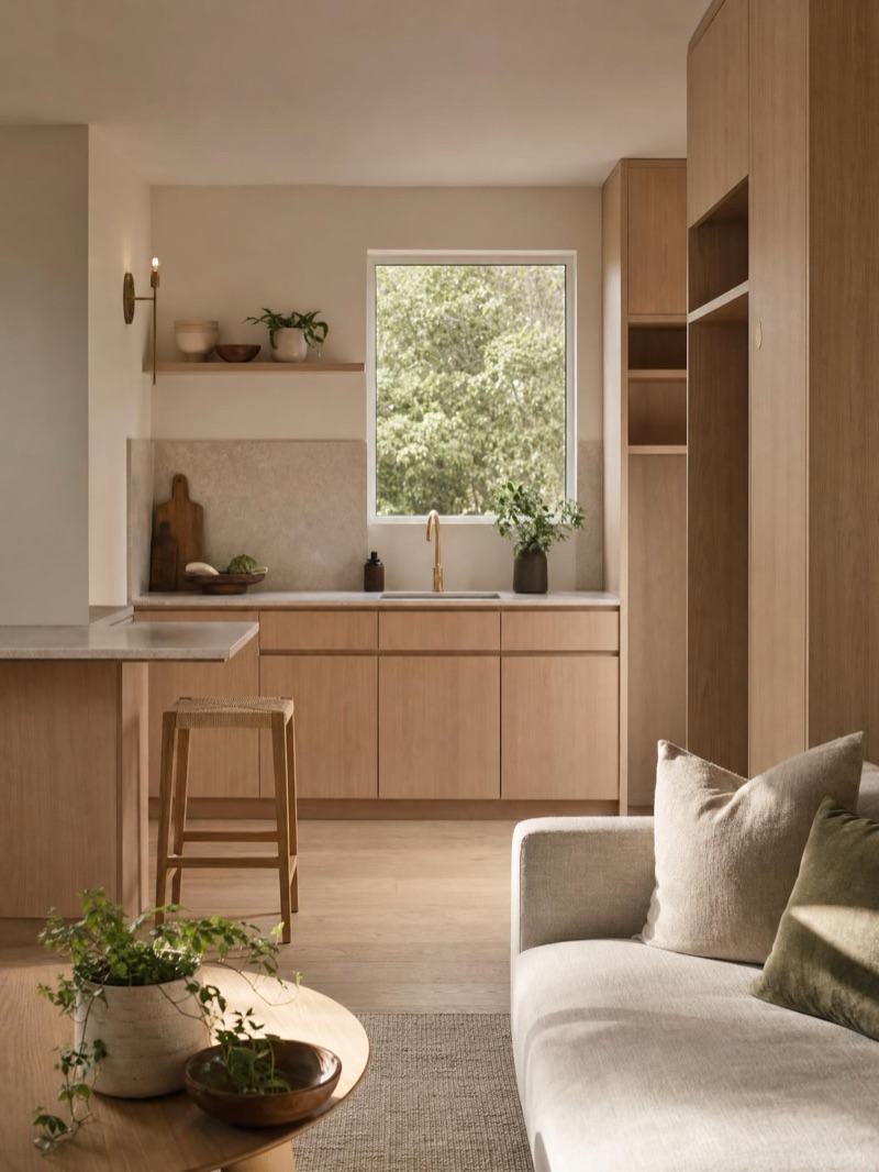 Self-contained secondary-dwelling interior — a compact kitchenette and living in pale oak and stone — illustrative concept