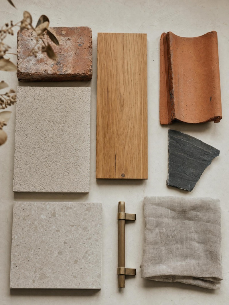 Home-extension materials matched to the original home — brick, render, timber and stone — illustrative concept